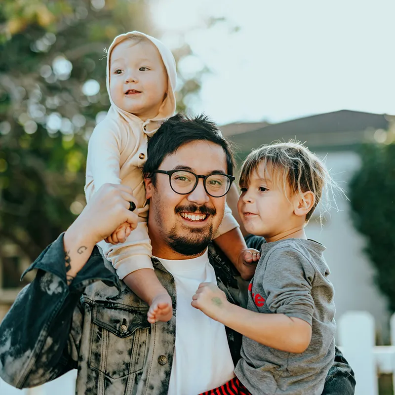 family-Wr3comVZJxU-unsplash man in white shirt carrying two kids